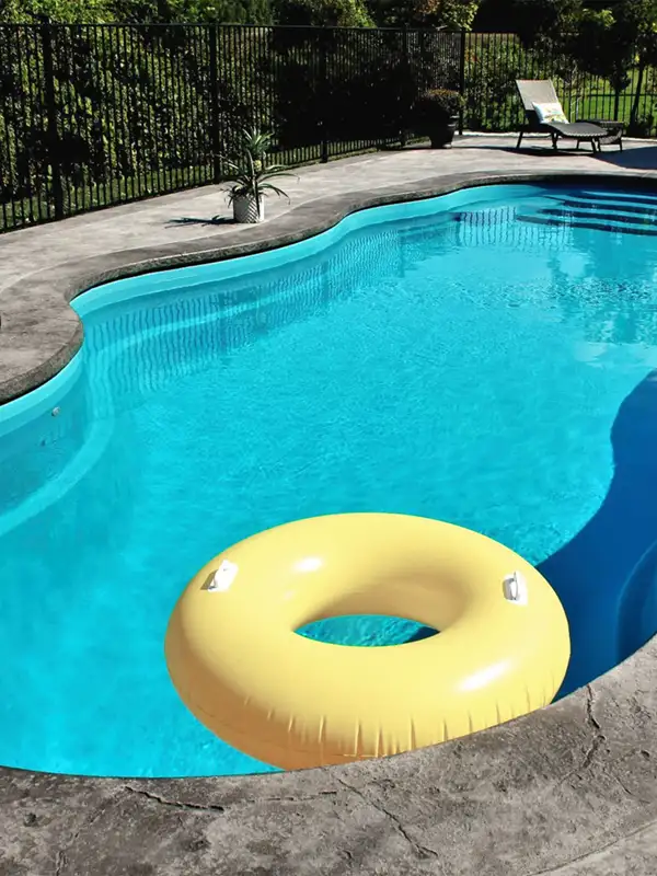 yellow inner tube floating on calm pool water