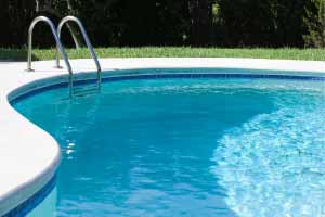 Clear blue outdoor pool with metal ladder