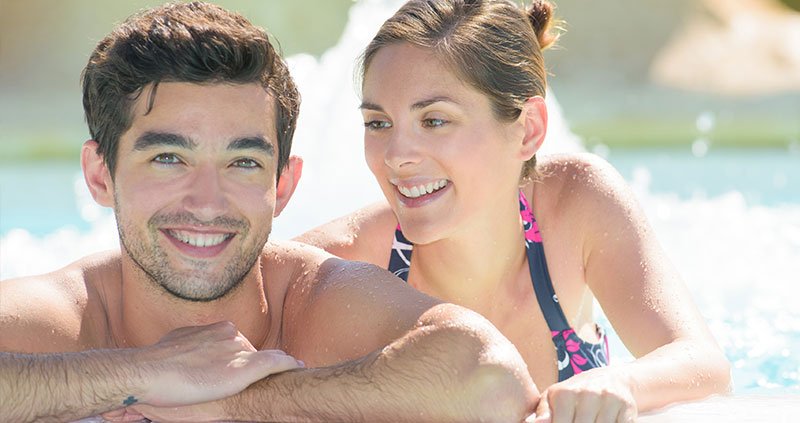 Two people relaxing at the edge of a hot tub