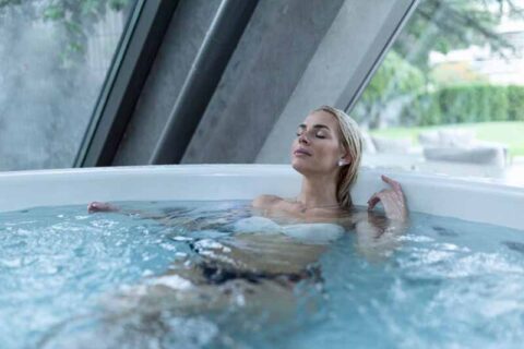 Person relaxing in an indoor hot tub.