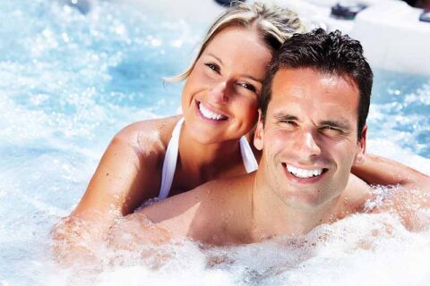 happy couple relaxing at hot tub