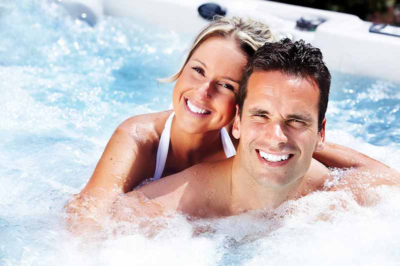Two people in a bubbling hot tub