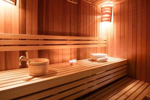 Wood-paneled indoor sauna with seating