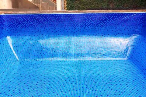 Empty swimming pool with blue tile-style vinyl liner