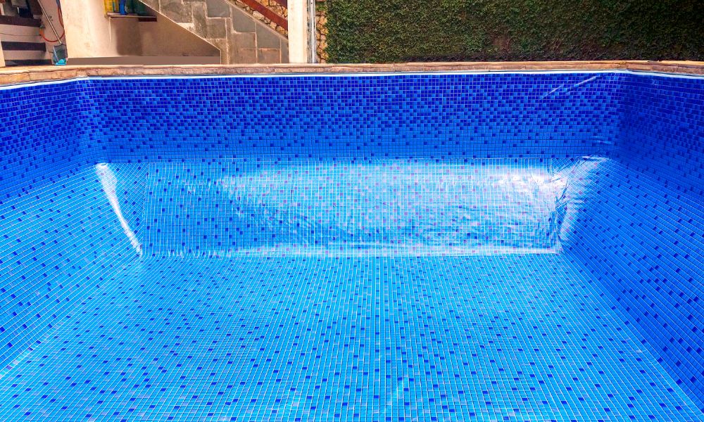 Empty swimming pool with blue tile-style vinyl liner